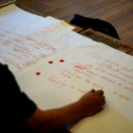 taking notes during summer retreat for Negotiation Education with PATHWAYS